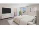 Large main bedroom with tv, ensuite access and large sunny window at 5231 Salt Marsh Rd, Wimauma, FL 33598