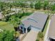 Aerial view of a well-maintained single-story home with a lush green lawn and a paver driveway at 5239 Admiral Pointe Dr, Apollo Beach, FL 33572
