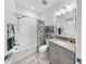 Bright bathroom featuring a shower-tub combo with a rainfall shower head and modern fixtures at 5239 Admiral Pointe Dr, Apollo Beach, FL 33572