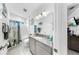Bright bathroom featuring granite countertop, tiled shower, and coastal decor at 5239 Admiral Pointe Dr, Apollo Beach, FL 33572