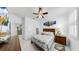 Inviting bedroom with ceiling fan, TV, closet, and floral bedding at 5239 Admiral Pointe Dr, Apollo Beach, FL 33572