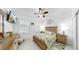 Cozy bedroom with shuttered windows, TV, ceiling fan, and light wood furniture at 5239 Admiral Pointe Dr, Apollo Beach, FL 33572