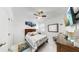 Comfortable bedroom with a ceiling fan, TV, plantation shutters, and coastal themed decor at 5239 Admiral Pointe Dr, Apollo Beach, FL 33572