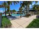 Resort-style community pool with lounge chairs and shaded areas, perfect for relaxation and recreation at 5239 Admiral Pointe Dr, Apollo Beach, FL 33572