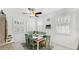 Well-lit dining room with plantation shutters, decor, wood furnishings, and ceiling fan at 5239 Admiral Pointe Dr, Apollo Beach, FL 33572