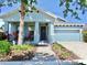 Charming single-Gathering home with a cozy front porch, manicured landscaping, and attached garage at 5239 Admiral Pointe Dr, Apollo Beach, FL 33572