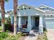 Inviting front porch with charming columns, manicured landscaping, and an attractive front door at 5239 Admiral Pointe Dr, Apollo Beach, FL 33572