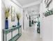 Long hallway with coastal decor, console tables, tile flooring, and recessed lighting at 5239 Admiral Pointe Dr, Apollo Beach, FL 33572