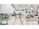 Bright kitchen features white cabinetry, granite countertops, stainless steel appliances, and tiled backsplash at 5239 Admiral Pointe Dr, Apollo Beach, FL 33572