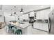 Bright kitchen featuring white cabinets, granite countertops, stainless steel appliances, and pendant lighting at 5239 Admiral Pointe Dr, Apollo Beach, FL 33572