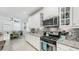 Well-appointed kitchen with white cabinets, a large center island, and stainless steel appliances at 5239 Admiral Pointe Dr, Apollo Beach, FL 33572