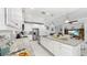 Open kitchen design with granite countertops, white cabinets, stainless steel appliances, and a kitchen island at 5239 Admiral Pointe Dr, Apollo Beach, FL 33572