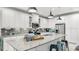 Modern kitchen with white cabinets, stainless steel appliances, a large island, and bar stool seating at 5239 Admiral Pointe Dr, Apollo Beach, FL 33572