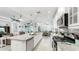 Bright and airy kitchen featuring a gas stove, stainless appliances, granite countertops, and center island at 5239 Admiral Pointe Dr, Apollo Beach, FL 33572