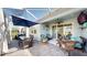 Outdoor dining and lounge area in a screened lanai overlooking the backyard at 5239 Admiral Pointe Dr, Apollo Beach, FL 33572
