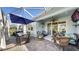 Outdoor dining and lounge area in a screened lanai overlooking the backyard at 5239 Admiral Pointe Dr, Apollo Beach, FL 33572