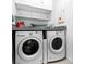 Functional laundry area features a washer, dryer, and overhead storage for convenience at 5239 Admiral Pointe Dr, Apollo Beach, FL 33572