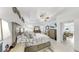Inviting primary bedroom featuring coastal decor, tray ceiling, ceiling fan, and adjacent sitting room at 5239 Admiral Pointe Dr, Apollo Beach, FL 33572