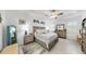 Calm main bedroom featuring tray ceilings, coastal decor, ceiling fan, tiled floors, and shutters at 5239 Admiral Pointe Dr, Apollo Beach, FL 33572