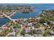 Stunning aerial view of a waterfront home with lush landscaping, a pool, and bay access at 556 21St Ne Ave, St Petersburg, FL 33704