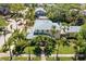 Aerial view of a yellow two-story home with lush landscaping including mature palm trees at 556 21St Ne Ave, St Petersburg, FL 33704