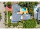 Aerial view of a two-story home featuring a swimming pool, a patio, and lush landscaping at 556 21St Ne Ave, St Petersburg, FL 33704