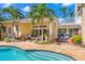 The backyard features a luxurious pool with stone patio, outdoor seating and access to the home's balcony at 556 21St Ne Ave, St Petersburg, FL 33704