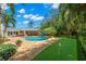Beautiful backyard with a pool, putting green, outdoor kitchen, and lush landscaping at 556 21St Ne Ave, St Petersburg, FL 33704