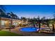 Secluded backyard oasis featuring a sparkling pool, outdoor lounge, and lush landscaping for relaxing evenings at 556 21St Ne Ave, St Petersburg, FL 33704