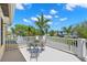 Enjoy scenic views from this spacious balcony with charming outdoor seating and white railings at 556 21St Ne Ave, St Petersburg, FL 33704