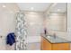 Well-lit bathroom featuring stylish granite countertop, tub with shower, and a floral shower curtain at 556 21St Ne Ave, St Petersburg, FL 33704