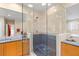 Modern bathroom featuring a glass shower, tiled walls, and dual vanities with granite counters at 556 21St Ne Ave, St Petersburg, FL 33704