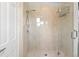 Beautiful, bright glass shower with marble tile, shower head, and built-in shower rack at 556 21St Ne Ave, St Petersburg, FL 33704