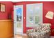 Cozy, quaint bedroom with light and bright walls, hardwood floors, and exterior access to yard at 556 21St Ne Ave, St Petersburg, FL 33704