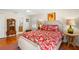 Bright bedroom with hardwood floors, neutral walls, and a lovely accent wall with unique wall art at 556 21St Ne Ave, St Petersburg, FL 33704