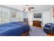 Comfortable bedroom featuring a ceiling fan, blue walls, wood floors, and a cozy sitting area at 556 21St Ne Ave, St Petersburg, FL 33704