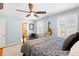 Comfortable bedroom with hardwood floors, shuttered windows, ceiling fan, and an acoustic guitar on the wall at 556 21St Ne Ave, St Petersburg, FL 33704