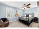 Light and airy bedroom with shuttered windows, ceiling fan, and a comfortable reading chair at 556 21St Ne Ave, St Petersburg, FL 33704