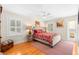 Cozy bedroom with hardwood floors, plantation shutters, stylish furnishings, and a decorative ceiling fan at 556 21St Ne Ave, St Petersburg, FL 33704