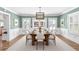 Bright dining room featuring traditional decor, green walls, white trim, and an elegant chandelier over a wooden table at 556 21St Ne Ave, St Petersburg, FL 33704