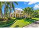 Stunning two-story home with a manicured lawn, tropical landscaping, and inviting front porch at 556 21St Ne Ave, St Petersburg, FL 33704