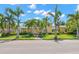 Inviting yellow two-story home featuring a porch and well-manicured front lawn with palm trees at 556 21St Ne Ave, St Petersburg, FL 33704