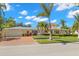 Charming yellow two-story home with a well-manicured lawn, brick driveway, and inviting curb appeal at 556 21St Ne Ave, St Petersburg, FL 33704