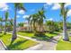 Beautiful yellow two-story home with a covered front porch and meticulously maintained landscaping and palm trees at 556 21St Ne Ave, St Petersburg, FL 33704