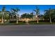 Inviting two-story home with a well-manicured lawn, classic design, and tropical palm trees at 556 21St Ne Ave, St Petersburg, FL 33704