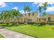 Charming yellow two-story home with a lush green lawn and manicured landscaping at 556 21St Ne Ave, St Petersburg, FL 33704