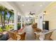 Inviting front porch with wicker furniture, ceiling fans, and a view of the manicured front yard at 556 21St Ne Ave, St Petersburg, FL 33704