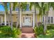 Inviting covered front porch with seating and white columns at 556 21St Ne Ave, St Petersburg, FL 33704