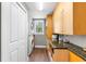 Bright laundry room with modern appliances, wooden cabinets and drawers, and a countertop at 556 21St Ne Ave, St Petersburg, FL 33704