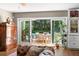 Living room with an outdoor dining patio and pool beyond the sliding glass doors at 556 21St Ne Ave, St Petersburg, FL 33704